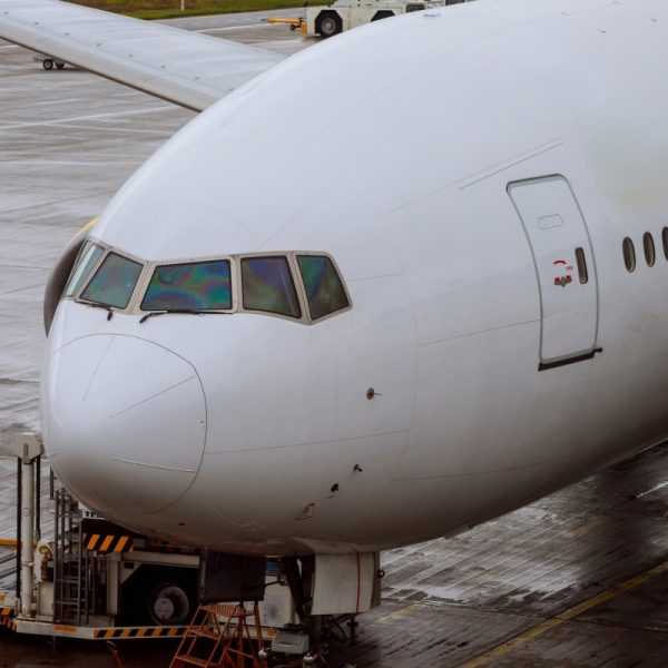 Airliner being prepared for boarding aircraft docked in airport loading cargo on the plane in